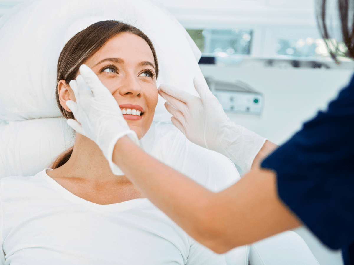 woman smiling in a dermatologist office